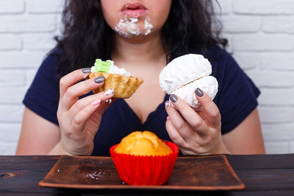 overweight woman eating sweets